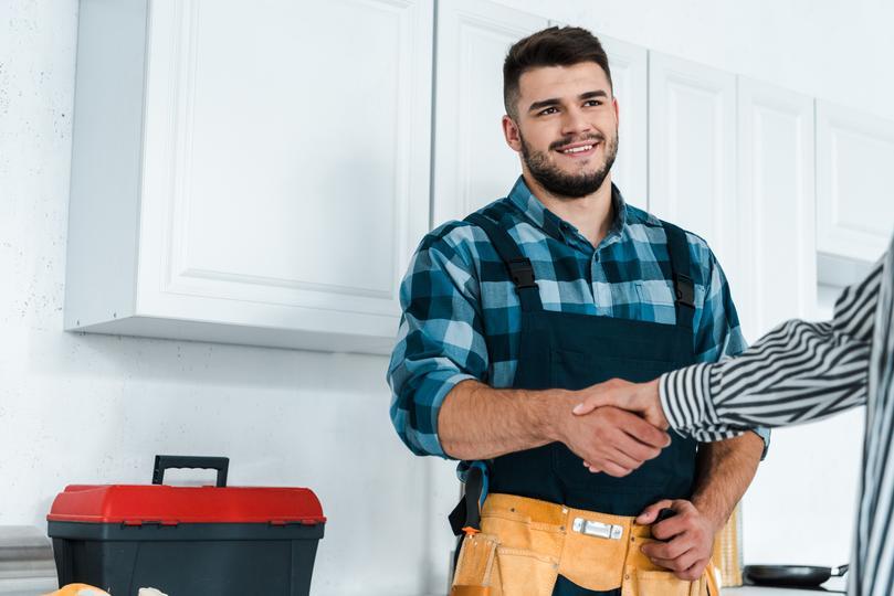 reputation-management-software for home service contractors  - local-contractor-shaking-hands-with-woman