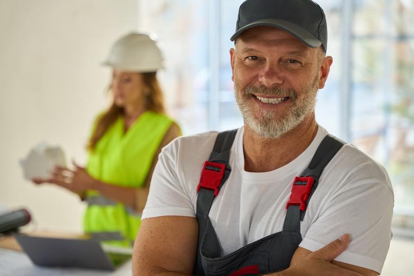 seo-agency for home service contractors  - portrait-of-smiling-home-contractor